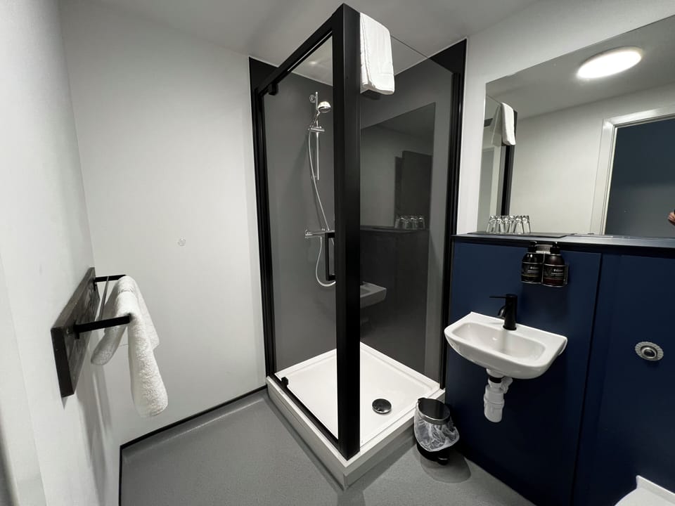 Shower, designer toiletries, hair dryer, towels