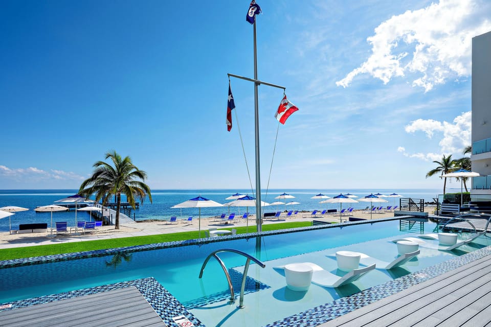 Heated resort pool with ledge loungers overlooking the beachfront. 