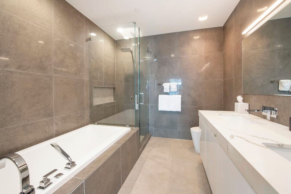 Primary Ensuite with dual vanity, soaking tub, and walk-in shower.