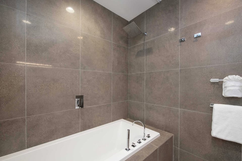Ensuite bathroom with tub and shower.