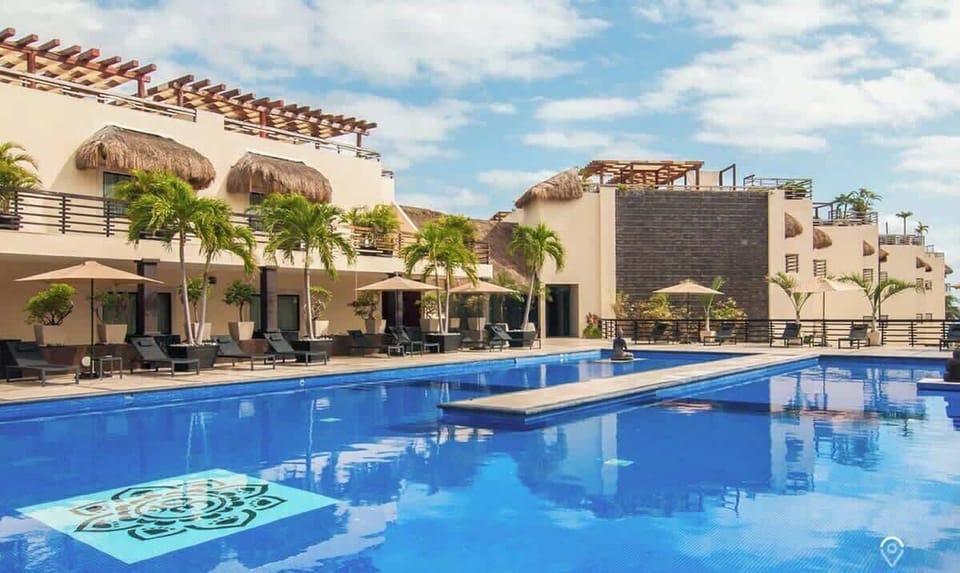 Relax by the expansive resort-style pool, surrounded by tropical palms.