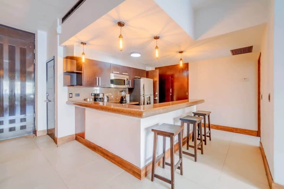 A breakfast bar at the kitchen counter with 3 stools.