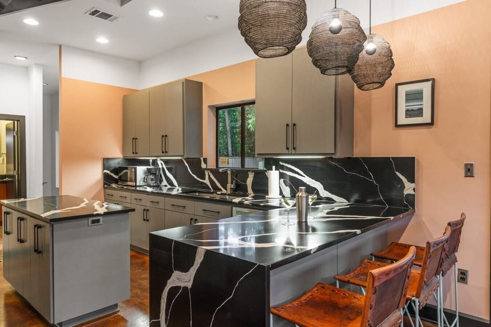 The newly renovated kitchen features stunning marble countertops and plenty of room to gather with friends.
