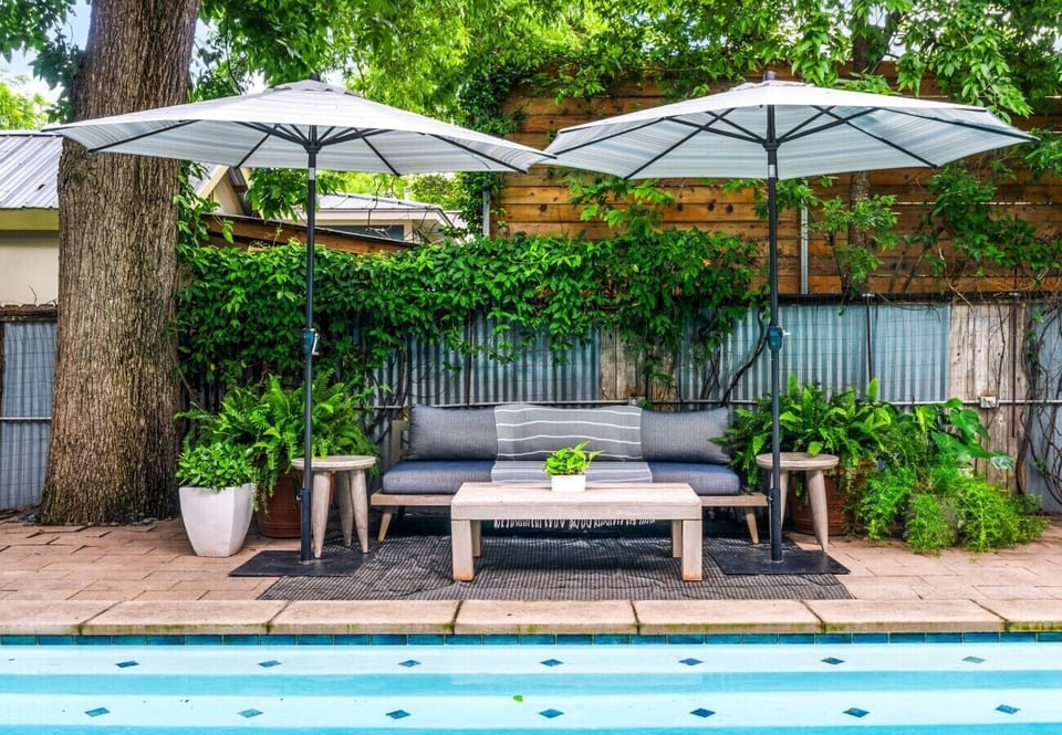 Comfortable outdoor couch seating with umbrellas for relaxing in the shade.