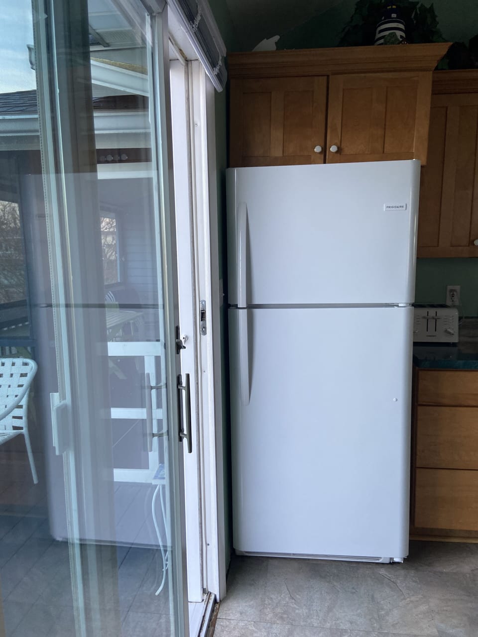 Kitchen with new appliances and sliding door to back deck.