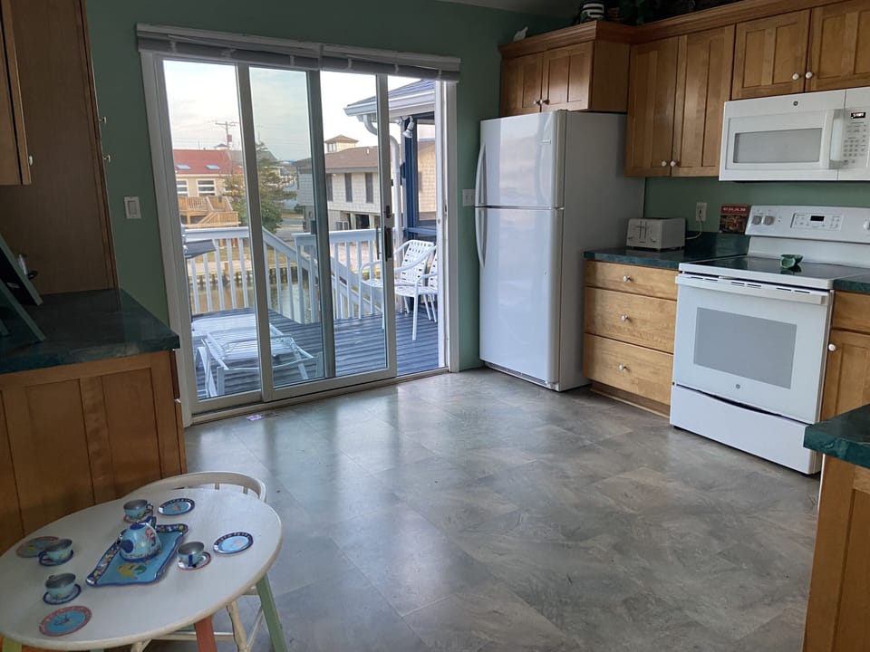 Kitchen with new appliances and sliding door to back deck.