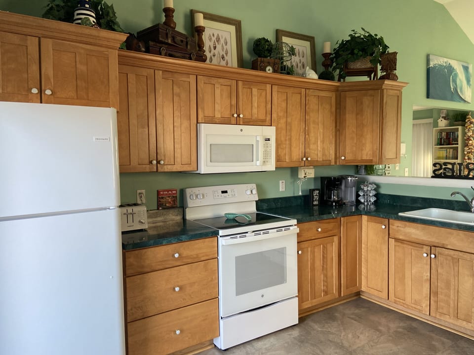 Kitchen with new appliances and sliding door to back deck.