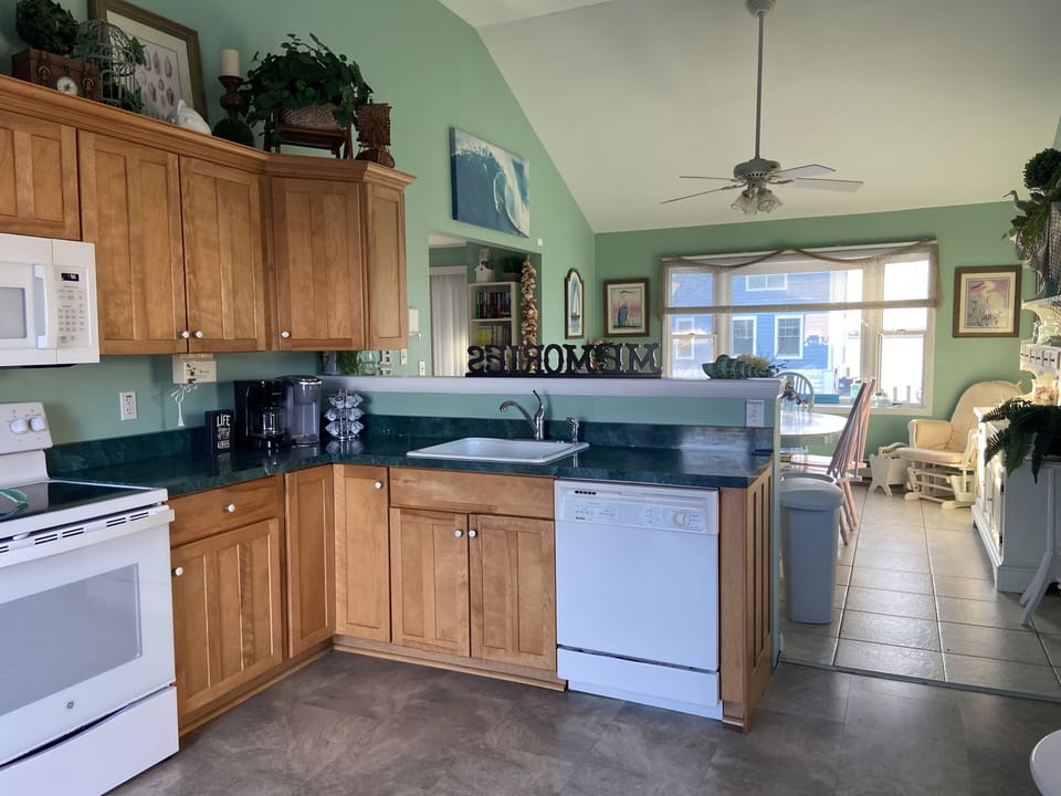 Kitchen with new appliances and sliding door to back deck.