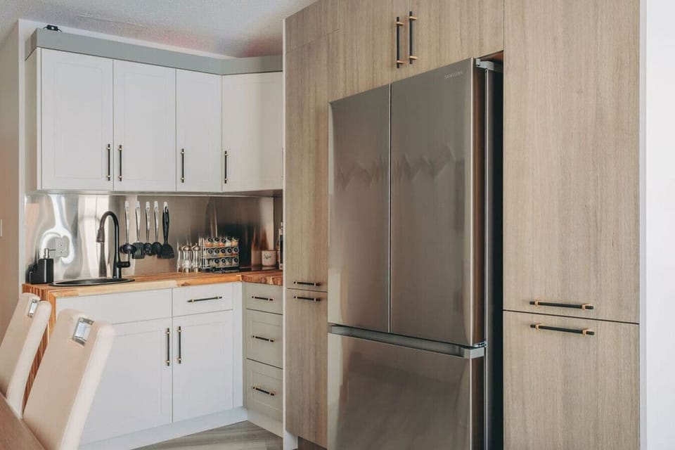 The kitchen with a large fridge and tons of storage.