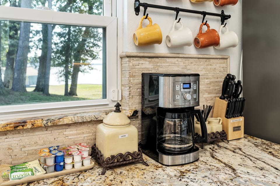 Coffee maker, coffee grounds, creamers, and sugar are provided.
