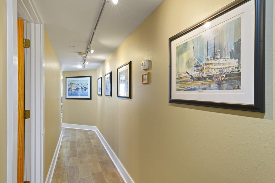 Step into this beautifully decorated hallway that leads you from the entrance to the open living spaces of this beachfront condo.
