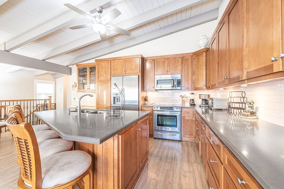 The kitchen is equipped with large and small appliances, dishes, bakeware, and cookware.
                