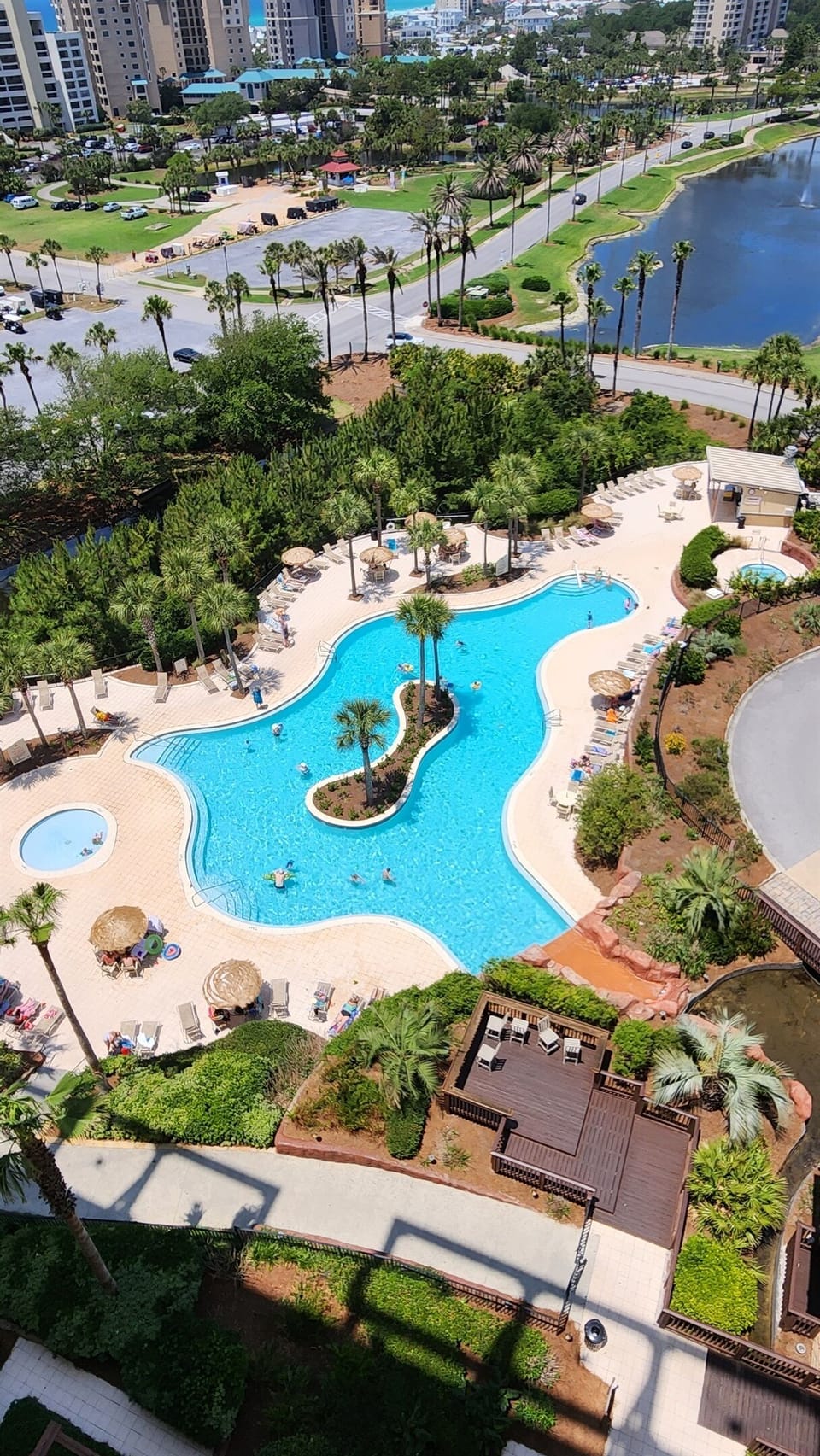 View showing: Kiddie pool, large resort pool and hot tub at the other end of the pool near the bar/food kiosk