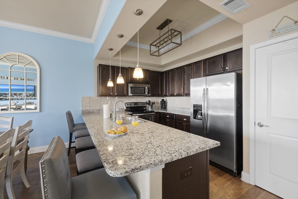 This open concept kitchen is fully stocked with all dishes, cookware and stainless steel appliances.
