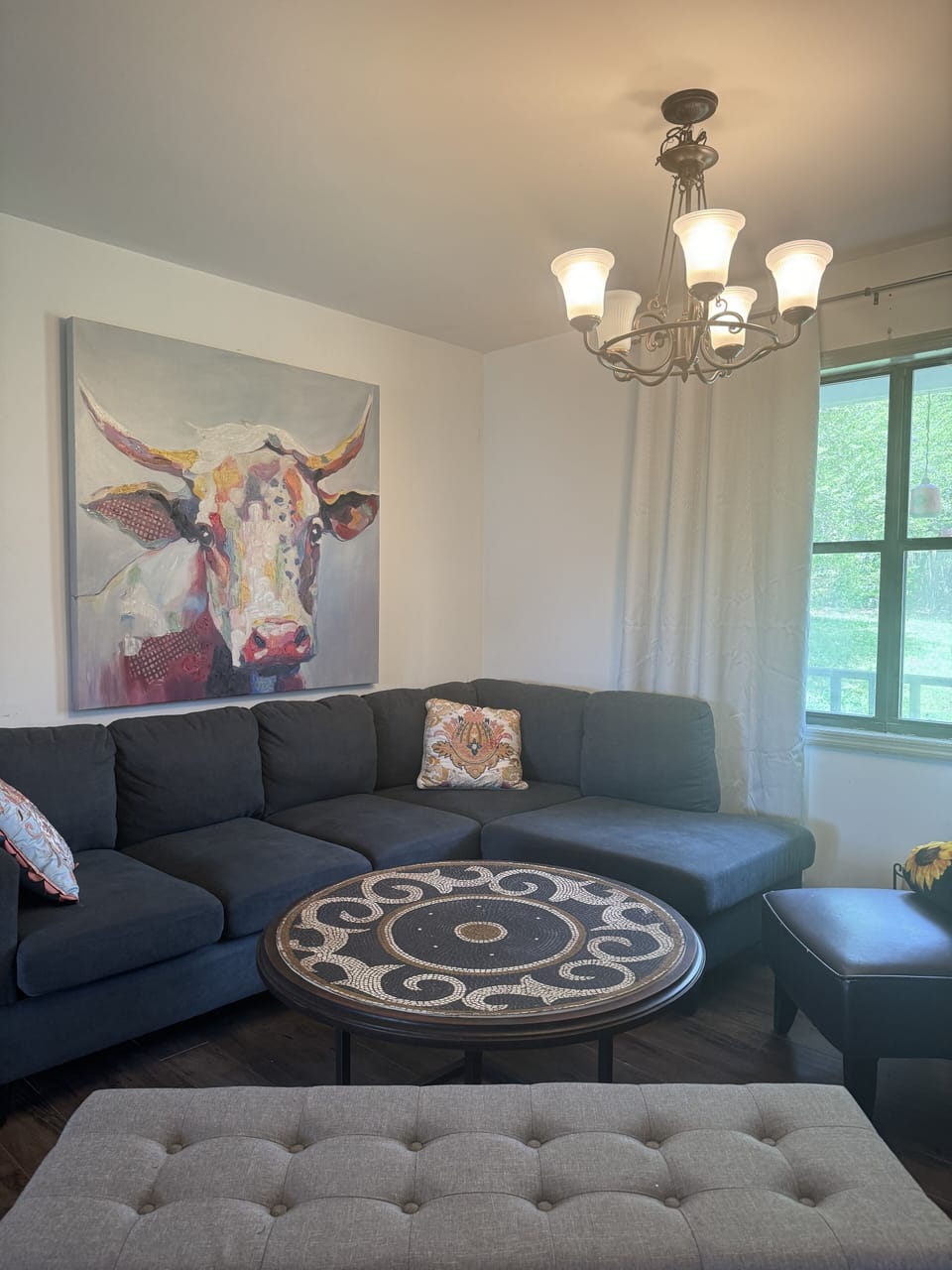 Our Living Room has a sectional sofa, table, seats & overlooks the Front Porch.