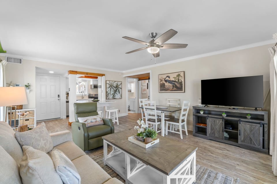 Relax in your comfortable, open-concept living space where coastal style meets home comfort. Unwind on plush seating, gather around the dining table, and enjoy your favorite shows on the big screen.