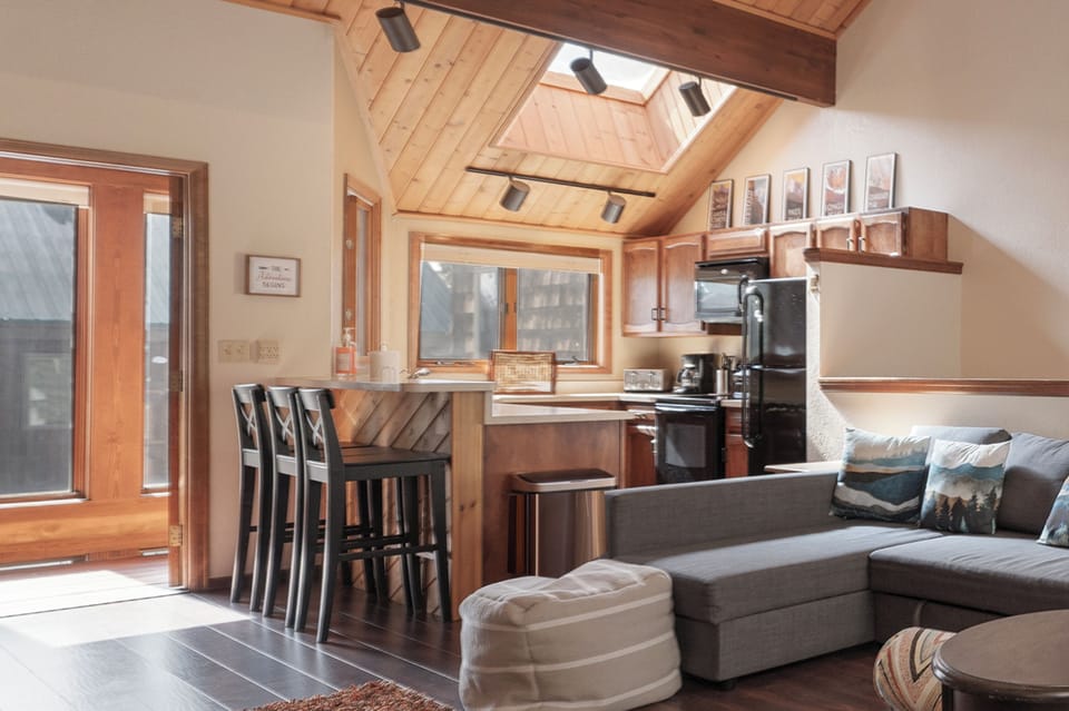 Your bright mountain retreat features warm wood beams, a skylight, and open kitchen perfect for cozy evenings.