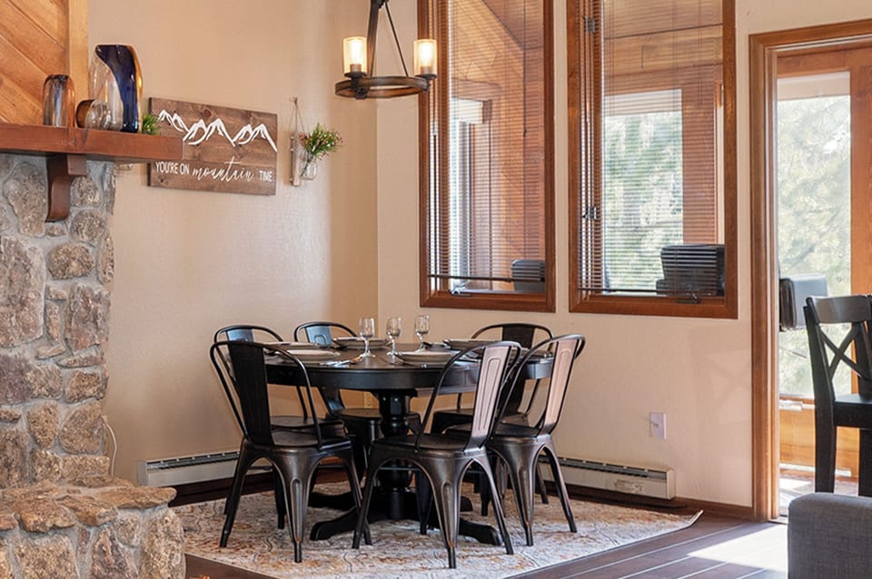 Gather around your stylish dining table where mountain adventures begin and memorable meals unfold in warm, rustic elegance.