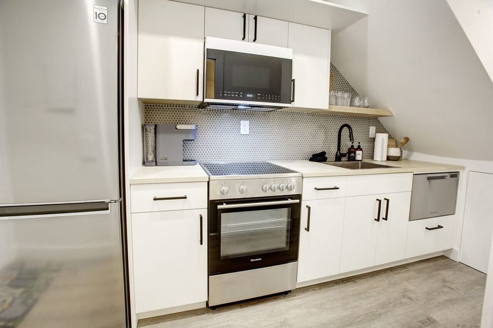 Large Fridge, Lots of appliances including: Toaster, microwave, oven, stove, kettle, coffee maker  more.