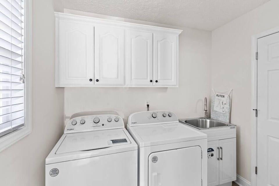 Washer, dryer, laundry sink, ironing board, iron, steamer