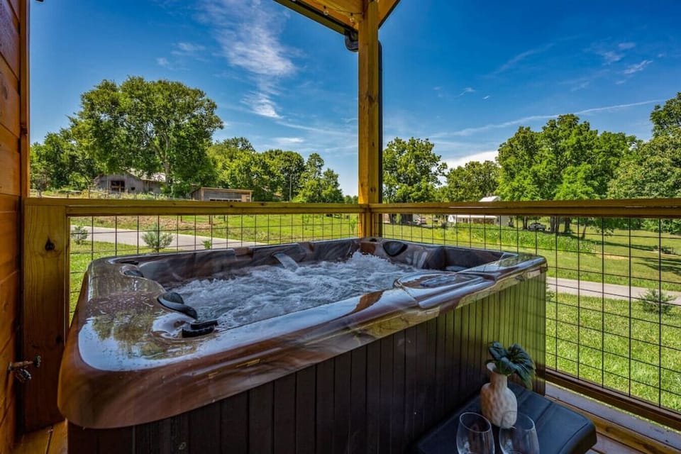 Spacious hot tub on covered deck.