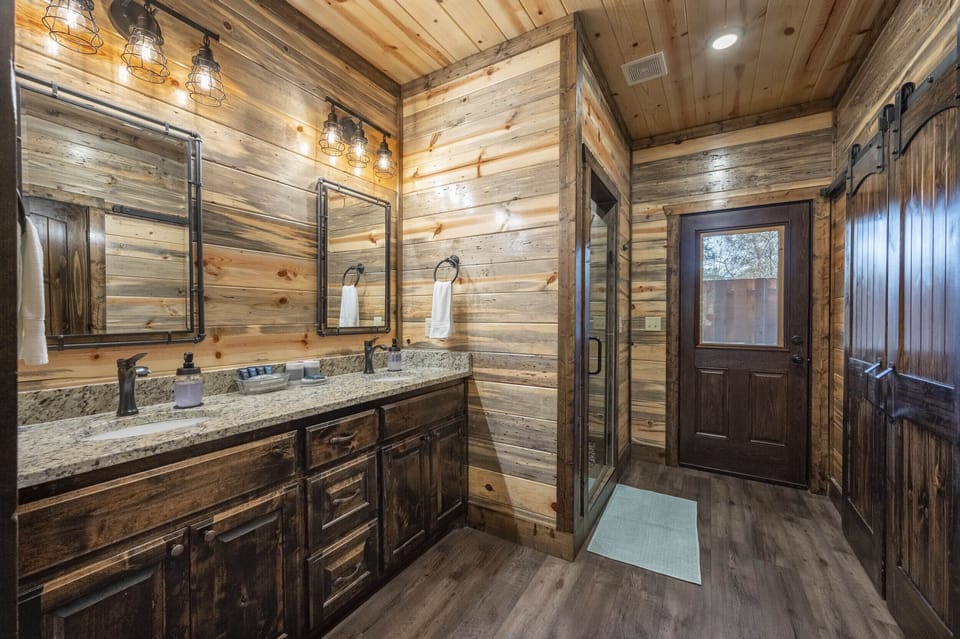 Bedroom 1 has an en suite bathroom that offers a seamless transition to the hot tub on the back deck.