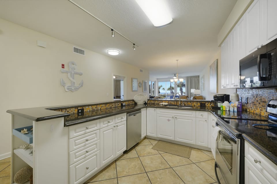 This fully equipped Destin beachfront condo kitchen makes family meals effortless after long days on the sugar white sands.