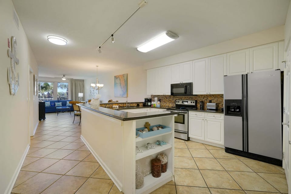 Granite countertops, stainless appliances, and thoughtful coastal details create a welcoming space that feels like your home by the sea.