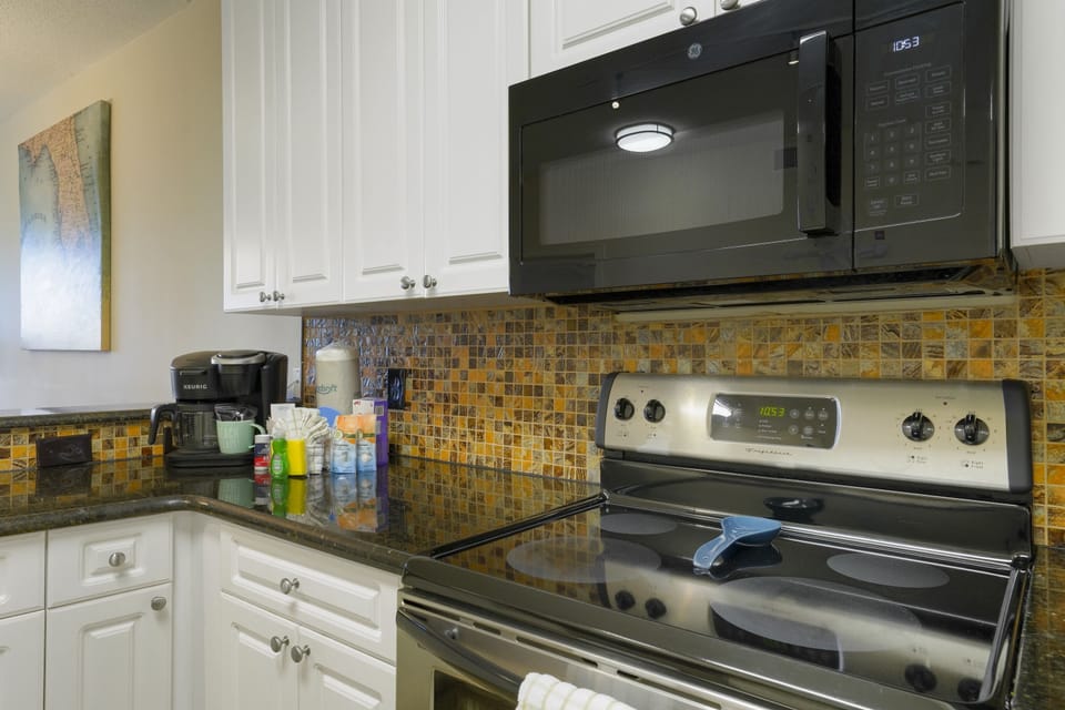 Granite countertops, stainless appliances, and thoughtful coastal details create a welcoming space that feels like your home by the sea.