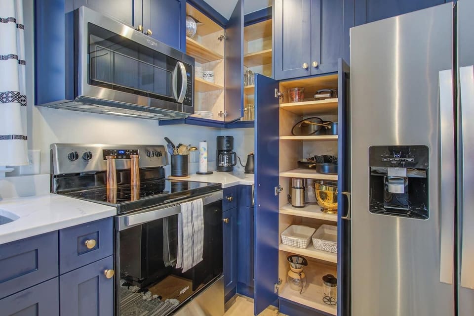 Stocked cabinets, complete with dinnerware, cooking utensils, cutlery, and glassware to celebrate the evening!