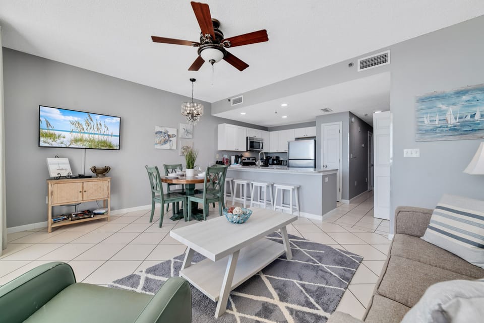 Light and airy living space featuring coastal-inspired decor and a seamless flow between the kitchen, living and dining areas.