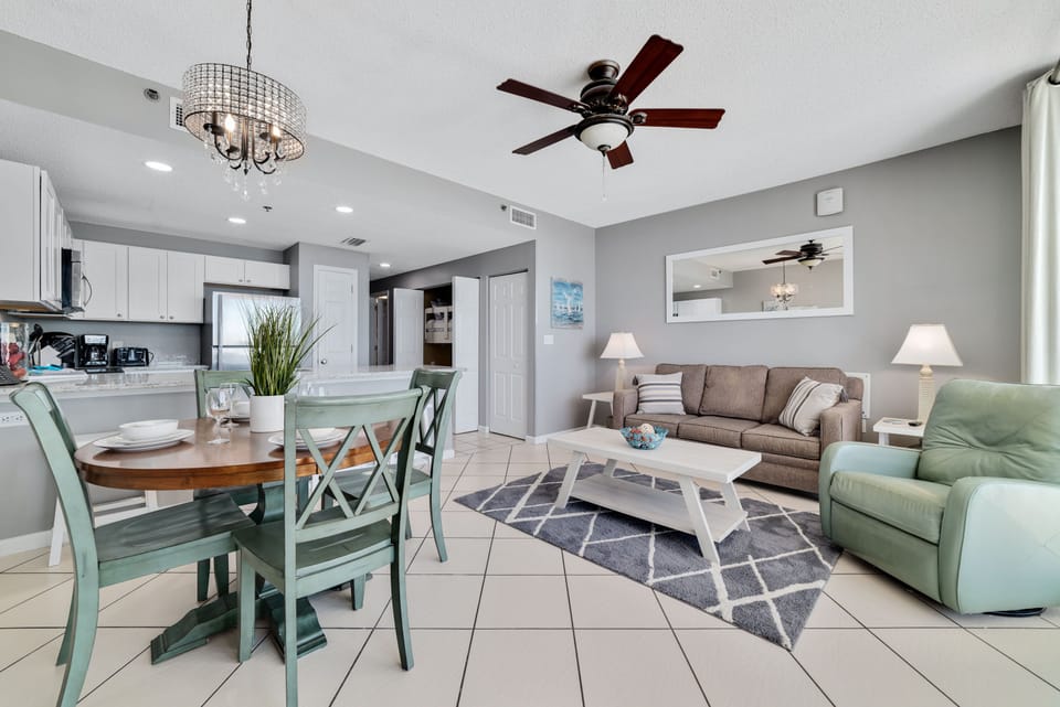 This well-appointed living space offers a comfortable sleeper sofa, coffee table, and a dining area with seating for four, creating a welcoming atmosphere.