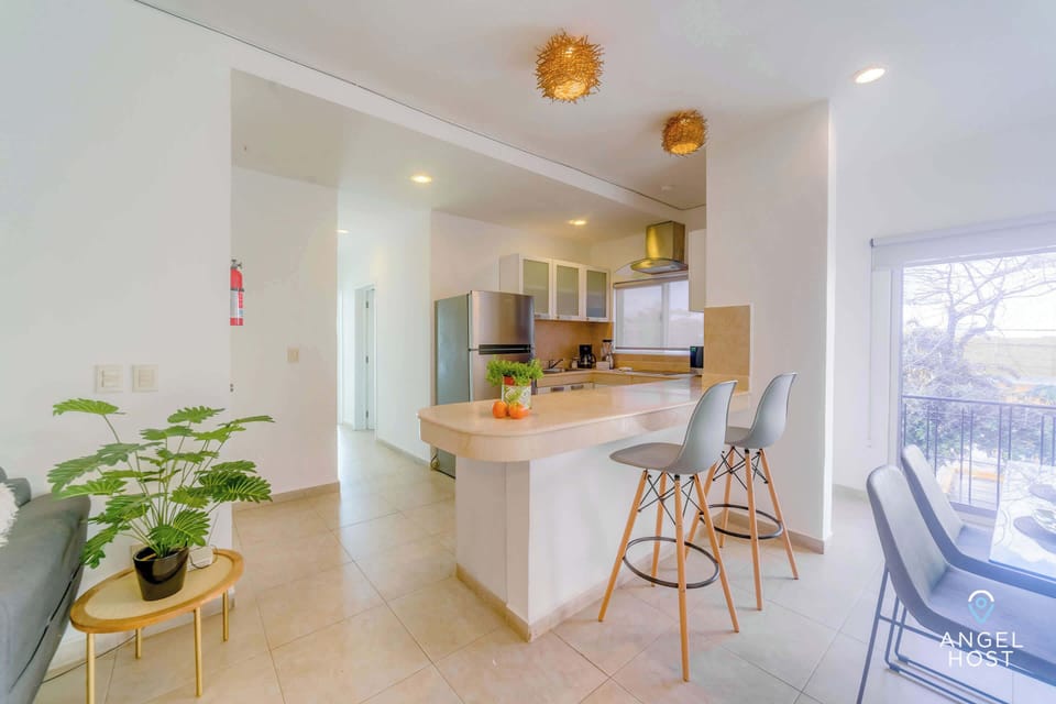 A breakfast bar with 2 stools that can double as a laptop-friendly workspace if needed