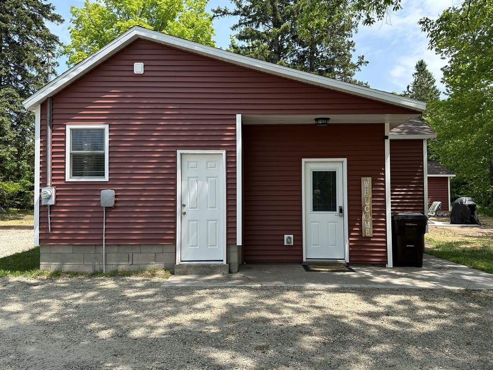 Entry door is on the right next to Welcome sign