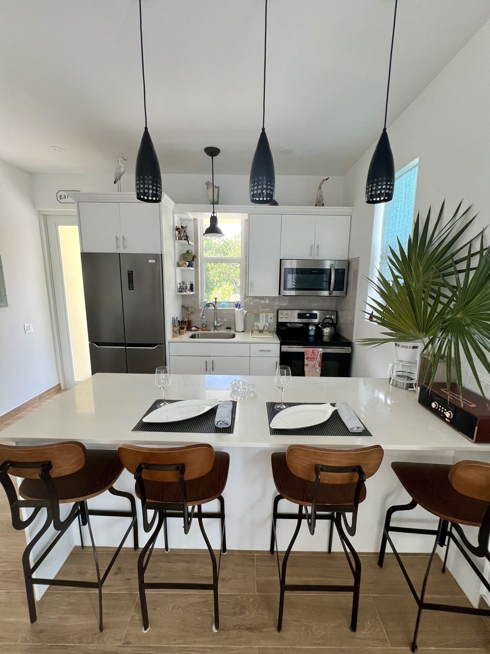 Eat in kitchen has 4 pull up chairs to island