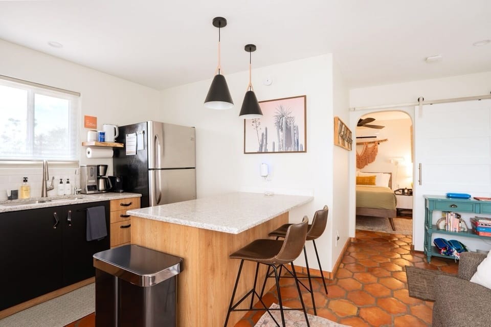 Casita kitchen with breakfast bar and full-size fridge for extra space.