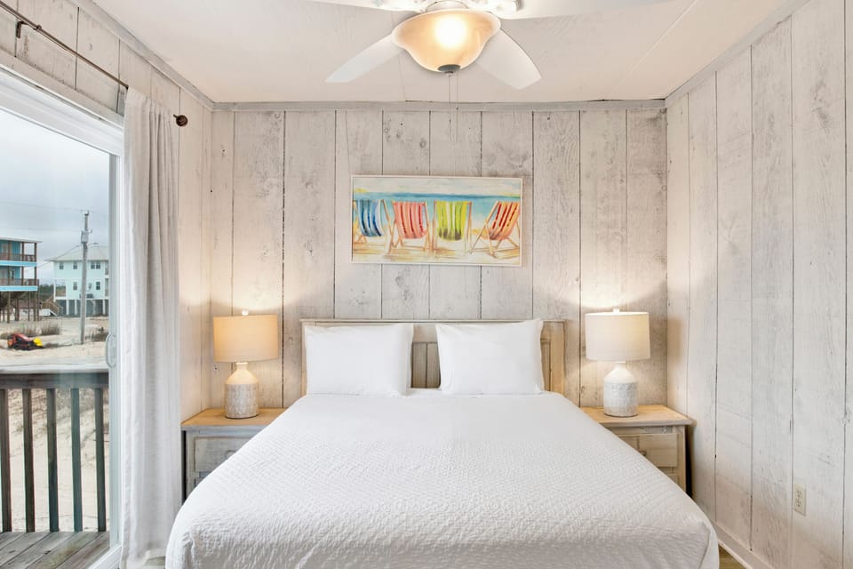 Guest bedroom 2 features a queen bed and shares the bathroom in the hall