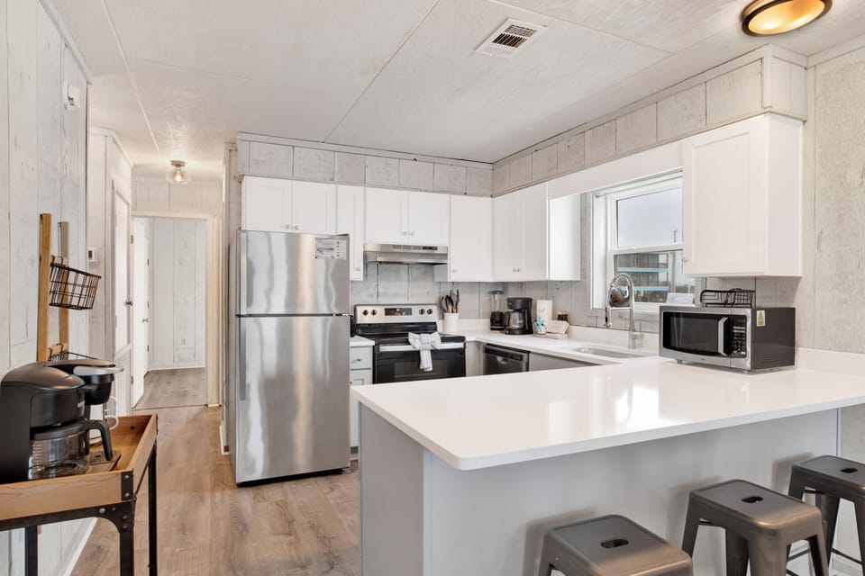 Renovated kitchen features new cabinets and granite counter tops