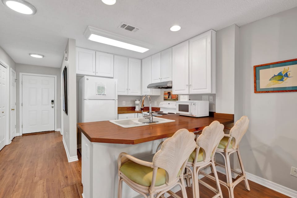 The kitchen is fully equipped and has additional bar seating