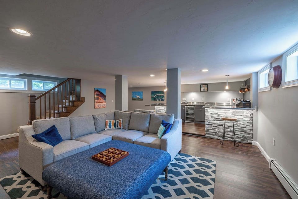 Transition to the lowest level with a second full living space and wet bar