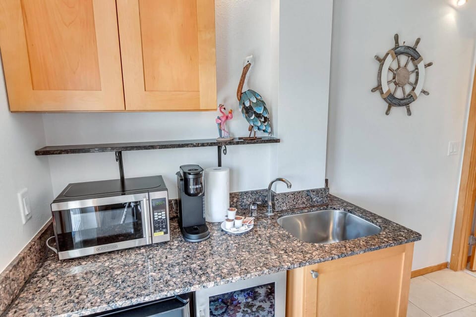 Enjoy the convenience of our kitchenette, featuring a Mini-Fridge, Wine Cooler, Microwave, Cook Top, Coffee Maker, Dishware, Utensils & Air Fryer.