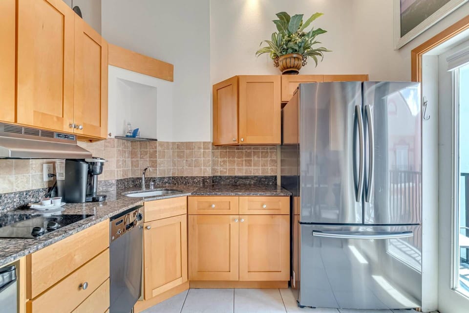 Enjoy the convenience of our kitchen, featuring a Refrigerator, Microwave, Cook Top, Coffee Maker, Dishware and Utensils