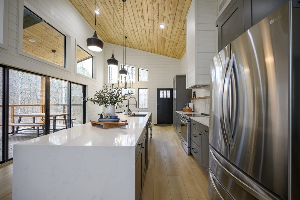 Luxury Kitchen Goals: Stunning waterfall island, high-end finishes, and all you need for a chef-inspired stay.