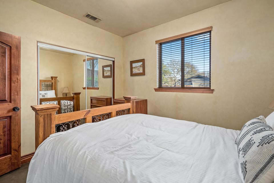Unwind in a bright bedroom with mirrored closet doors