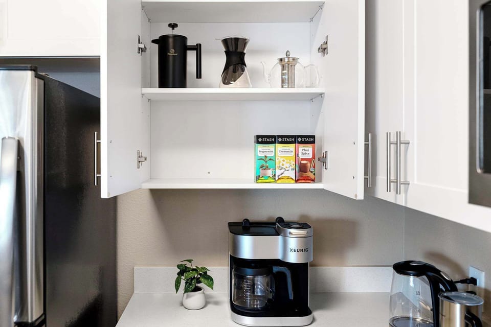 Inside the cupboard there are peppermint, chamomile, and chai spice teas