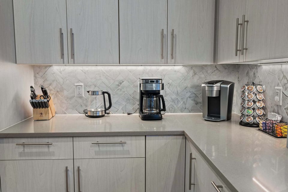 The kitchen is loaded with extras like a pressure cooker, mini waffle maker, electric kettle and more!