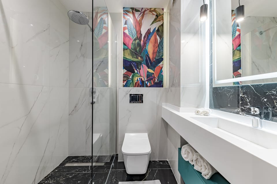 Shower, designer toiletries, hair dryer, bathrobes