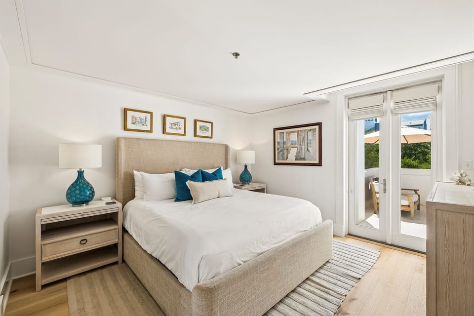 The primary bedroom offers a large space with comfortable king sized bed, large walk-in closet, ensuite bath, and direct access to the terrace.