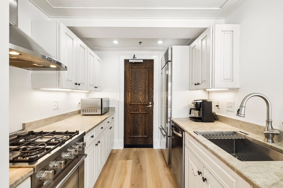 The kitchen has everything you need for a week at the beach.  Taj Mahal countertops, a gas range, and a large Viking refrigerator/freezer.