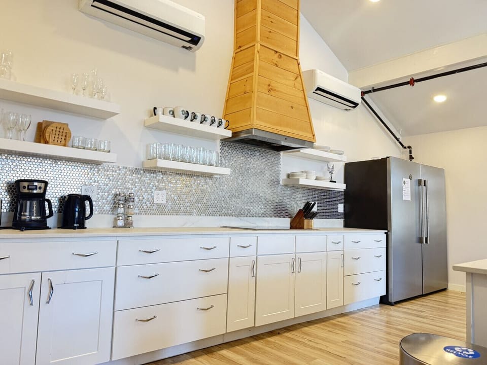 Kitchen view with large island and white cabinetry.